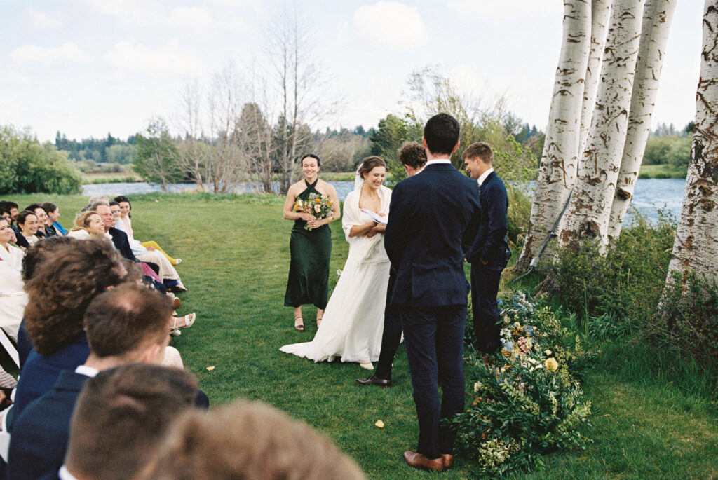 film image of a wedding ceremony with the bride smiling during vows