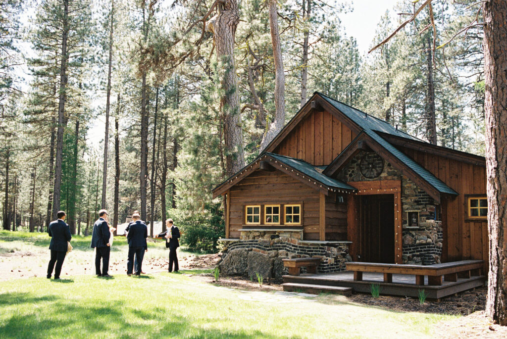 getting ready cabin at lake creek lodge with groomsmen mingling in front