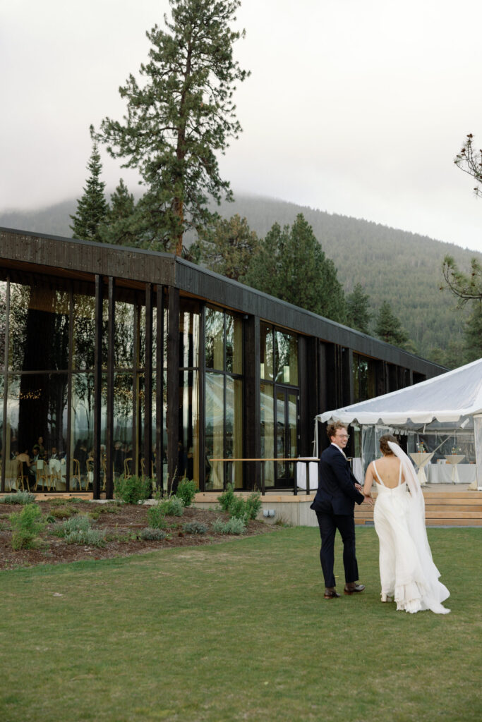 wedding couple running towards black butte ranch lodge