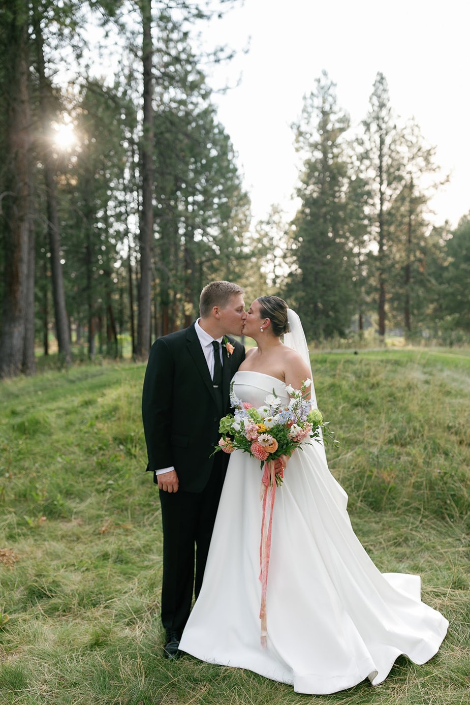 the bride and groom kissing at their central oregon wedding at white aspen creative