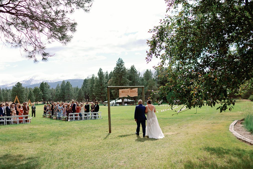 the bride walking down the aisle at pole creek ranch  captured by a bend wedding photographer