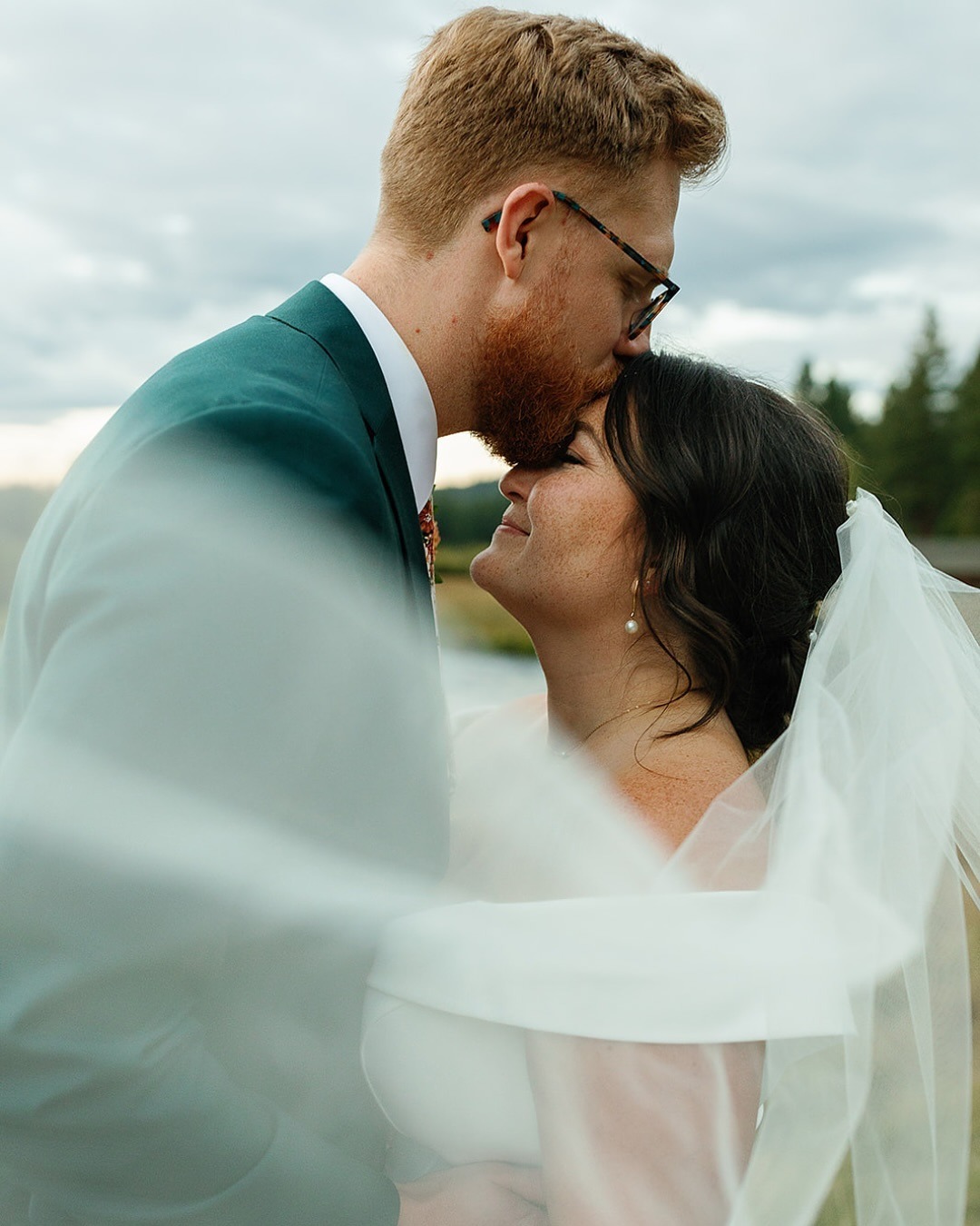 a groom kissing his bride at their bend oregon wedding