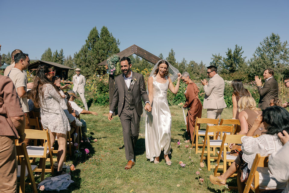 couple walking down the aisle after wedding ceremony at rainshadow organics farm